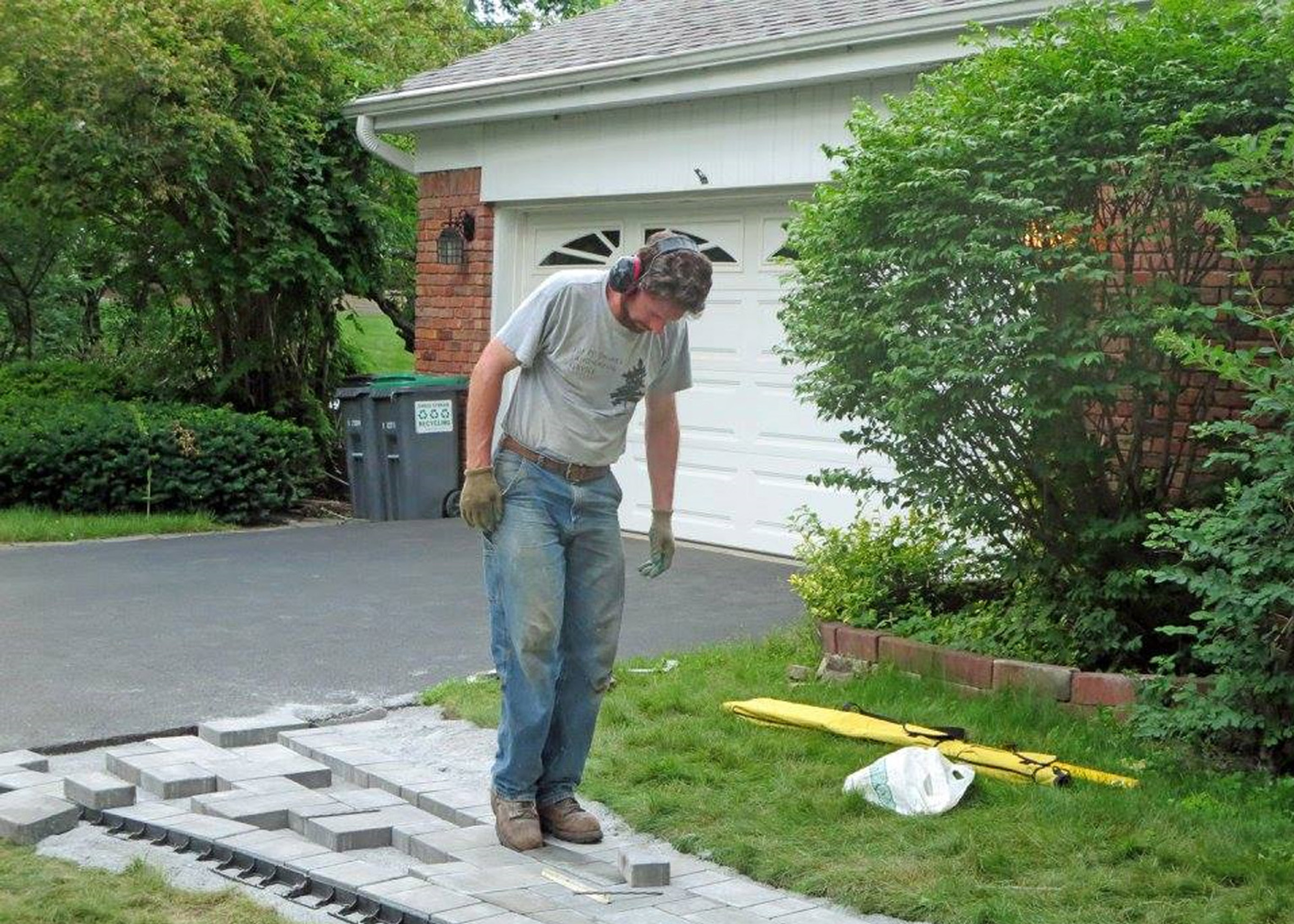 Installation of stone sidewalk in front of house