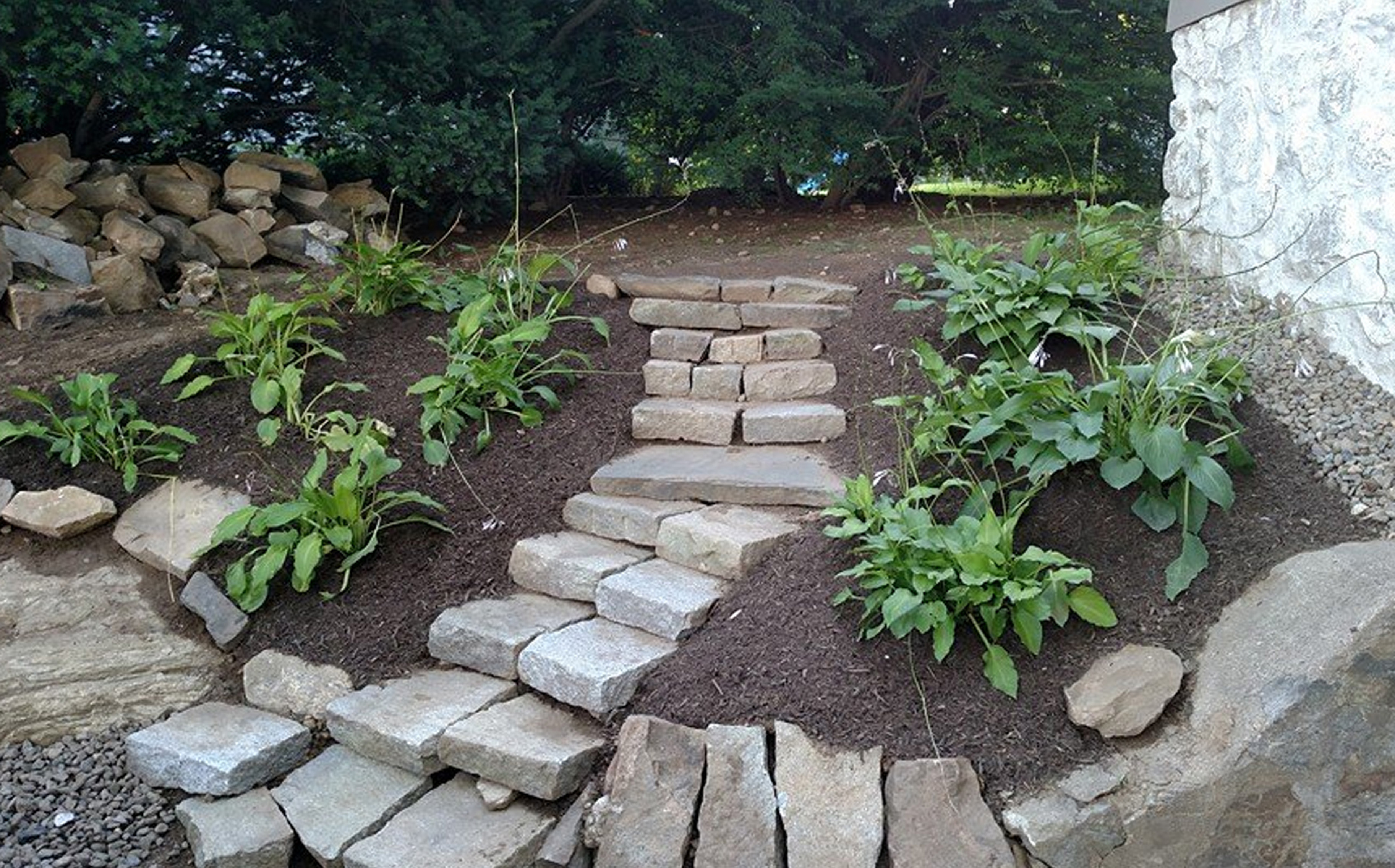 Thumbnail of completed plant bed, with stone stairs, mulch, and stone